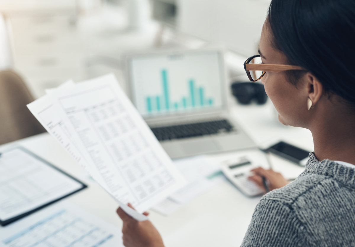 Closeup shot of an unrecognisable businesswoman calculating finances in an office
